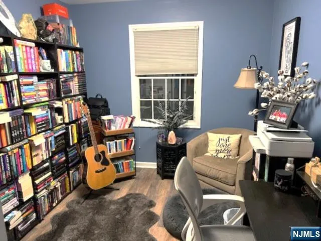 a living room with fireplace furniture and a book shelf