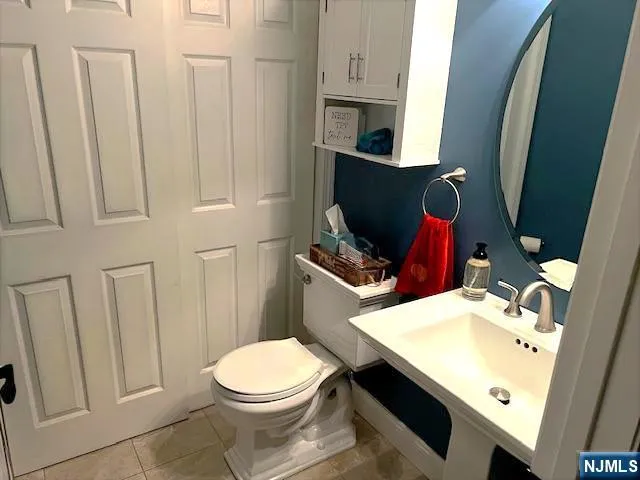 a bathroom with a sink toilet and mirror