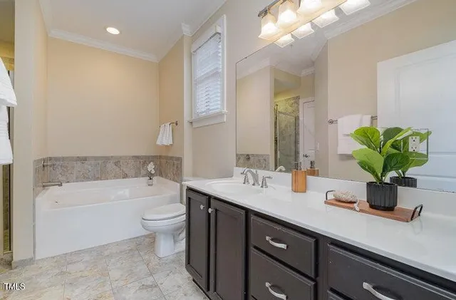 a bathroom with a sink a large mirror and a bathtub