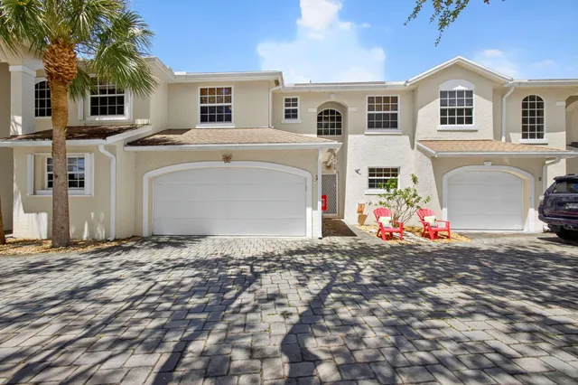 a view of a white house with a yard