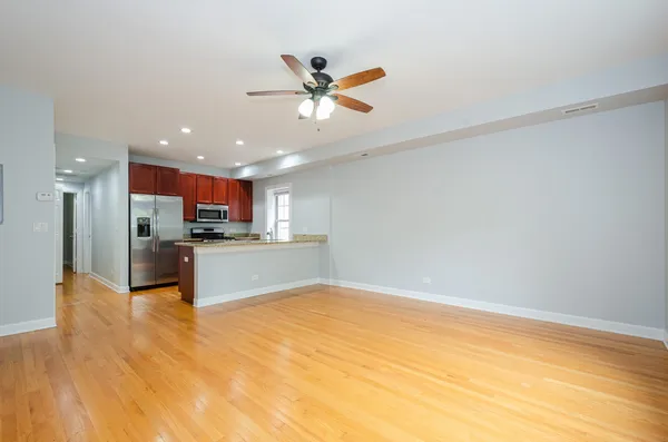 a view of kitchen with kitchen island a sink stainless steel appliances and cabinets