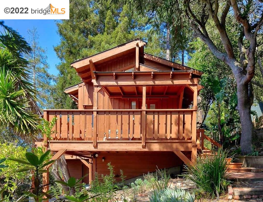 a view of a house with roof deck and furniture