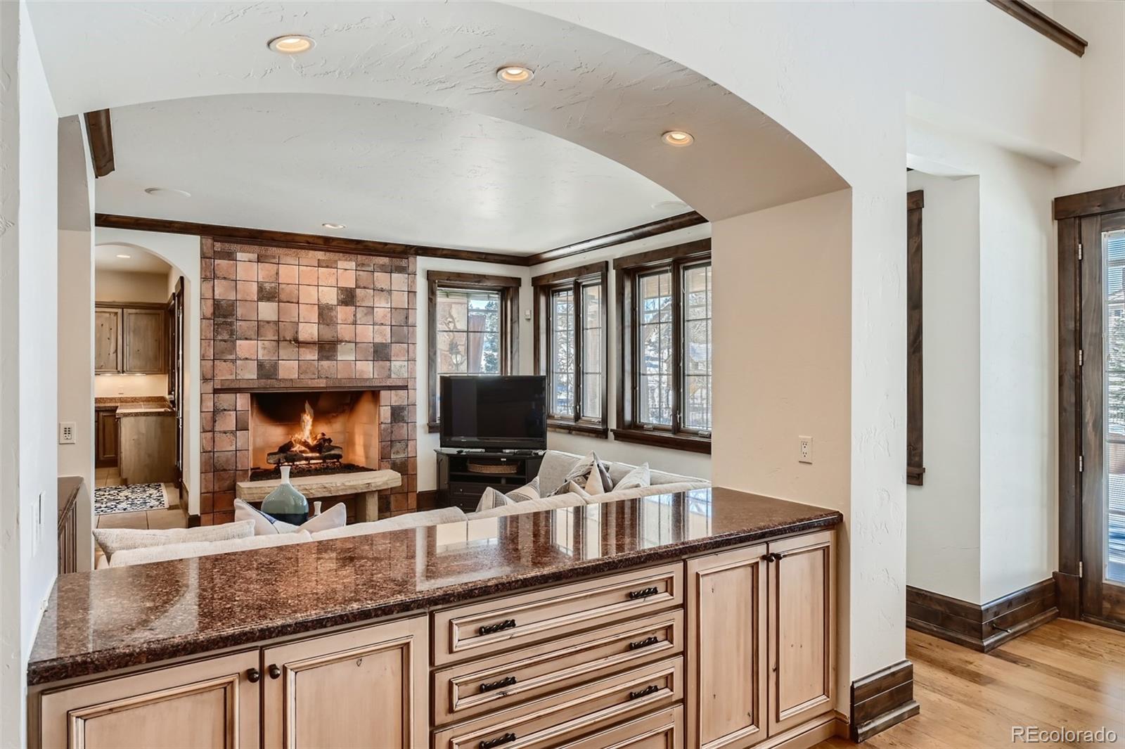 7390 Sagebrush Drive Parker, CO 80138 - Photo 16 of 40 a kitchen with granite countertop a sink a counter top space and cabinets