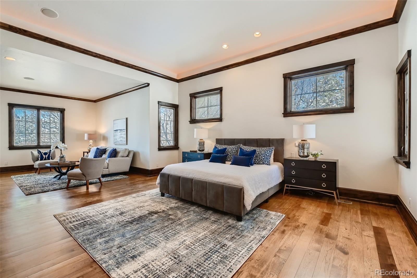 7390 Sagebrush Drive Parker, CO 80138 - Photo 17 of 40 a spacious bedroom with a bed a couch and a dresser