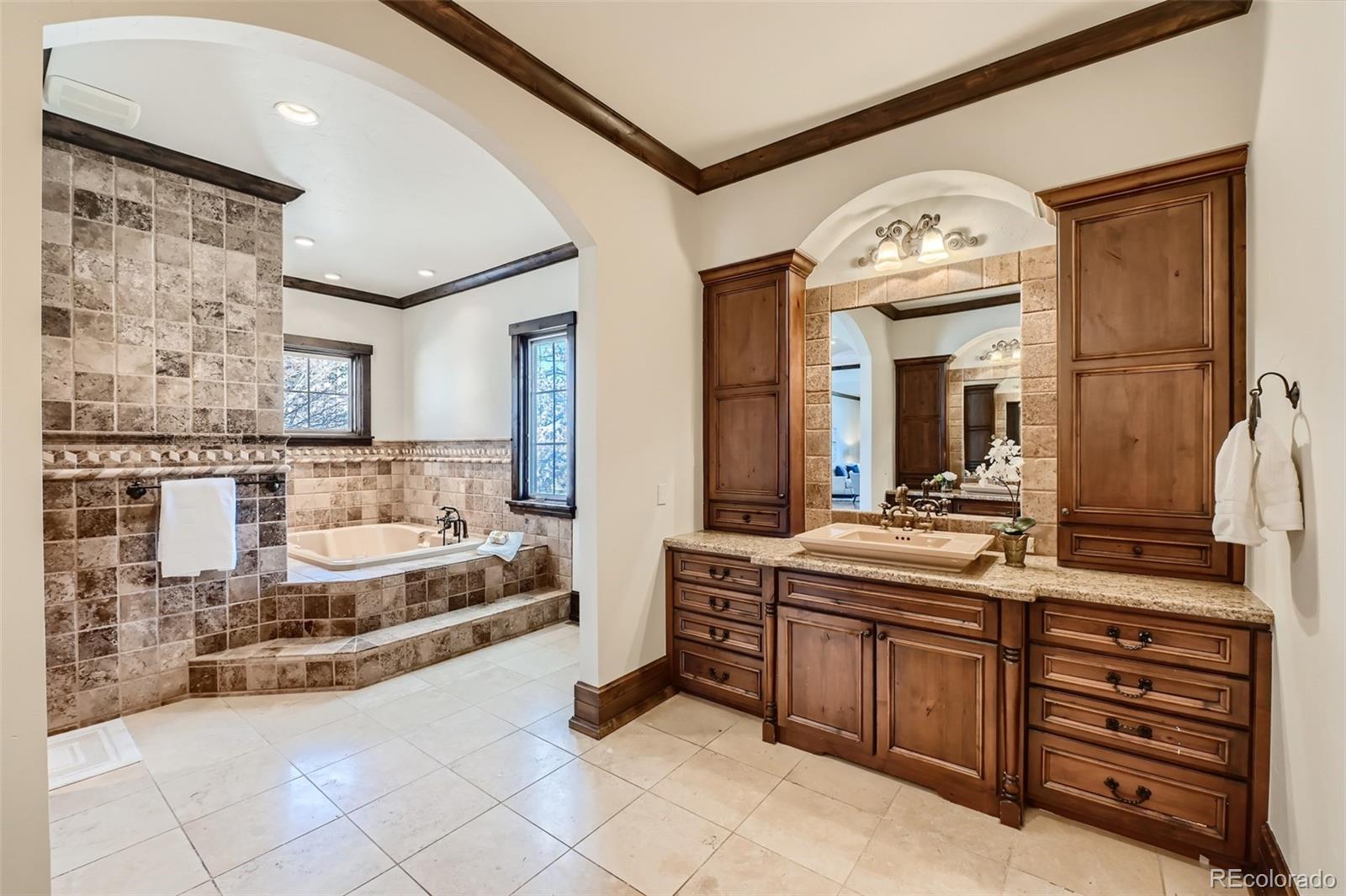 7390 Sagebrush Drive Parker, CO 80138 - Photo 20 of 40 a spacious bathroom with a double vanity sink double mirror and bathtub