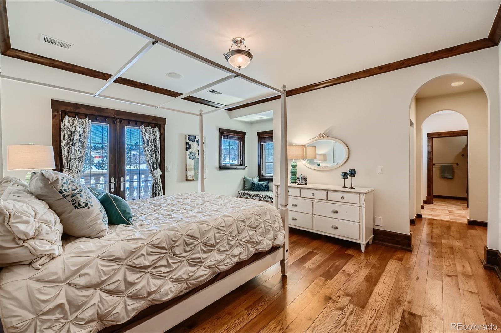 7390 Sagebrush Drive Parker, CO 80138 - Photo 25 of 40 a bed room with a bed and wooden floor