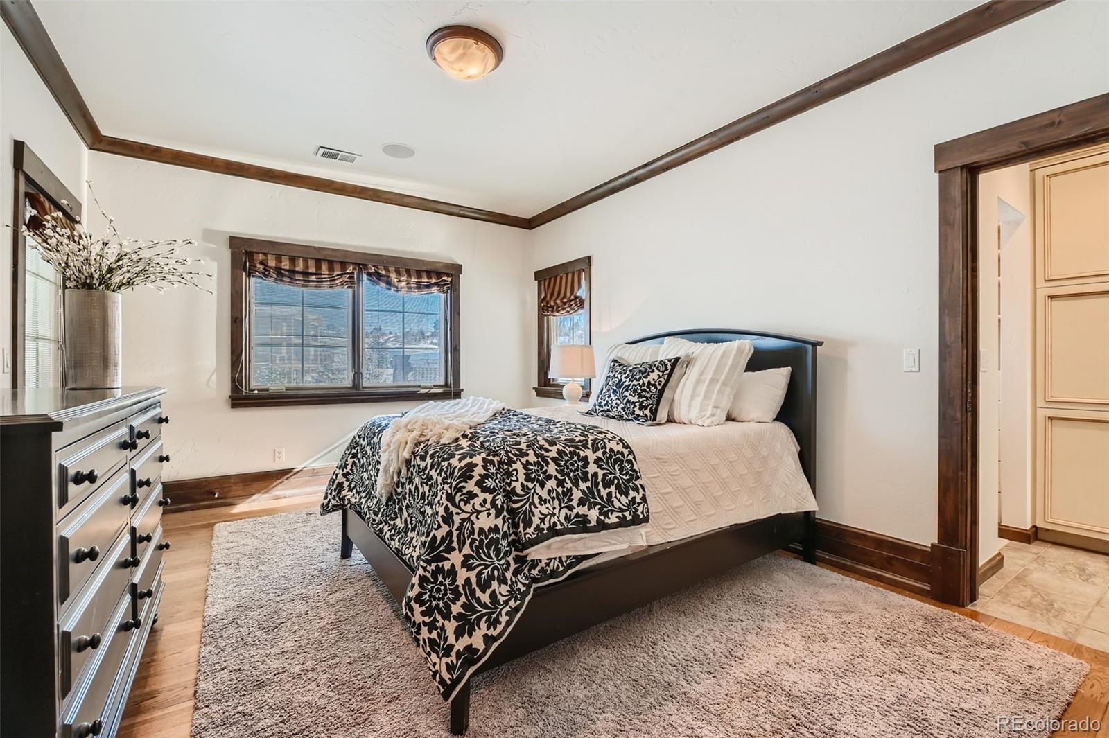 7390 Sagebrush Drive Parker, CO 80138 - Photo 29 of 40 a bedroom with a large bed and a window