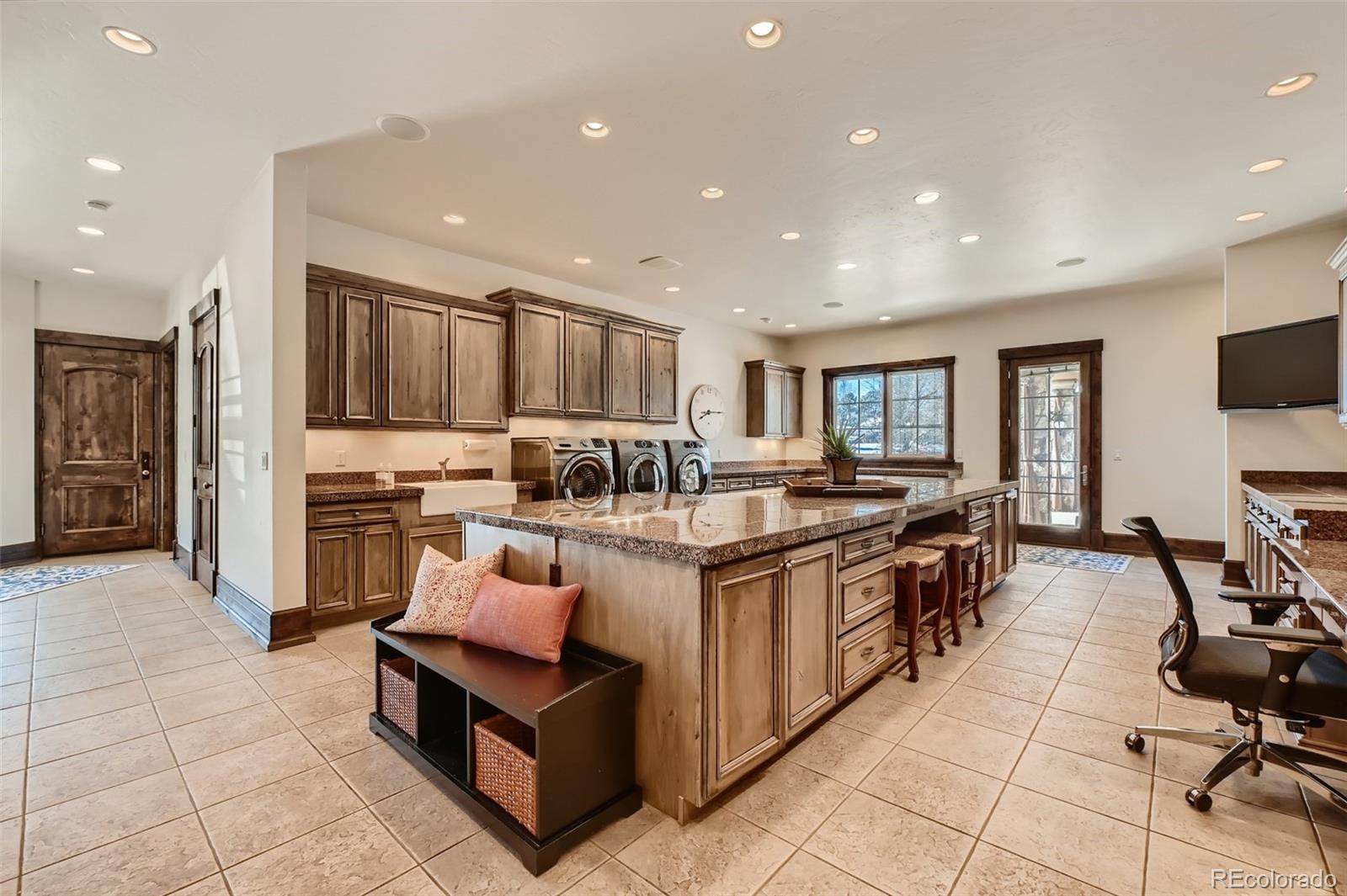 7390 Sagebrush Drive Parker, CO 80138 - Photo 33 of 40 a large kitchen with stainless steel appliances lots of counter top space