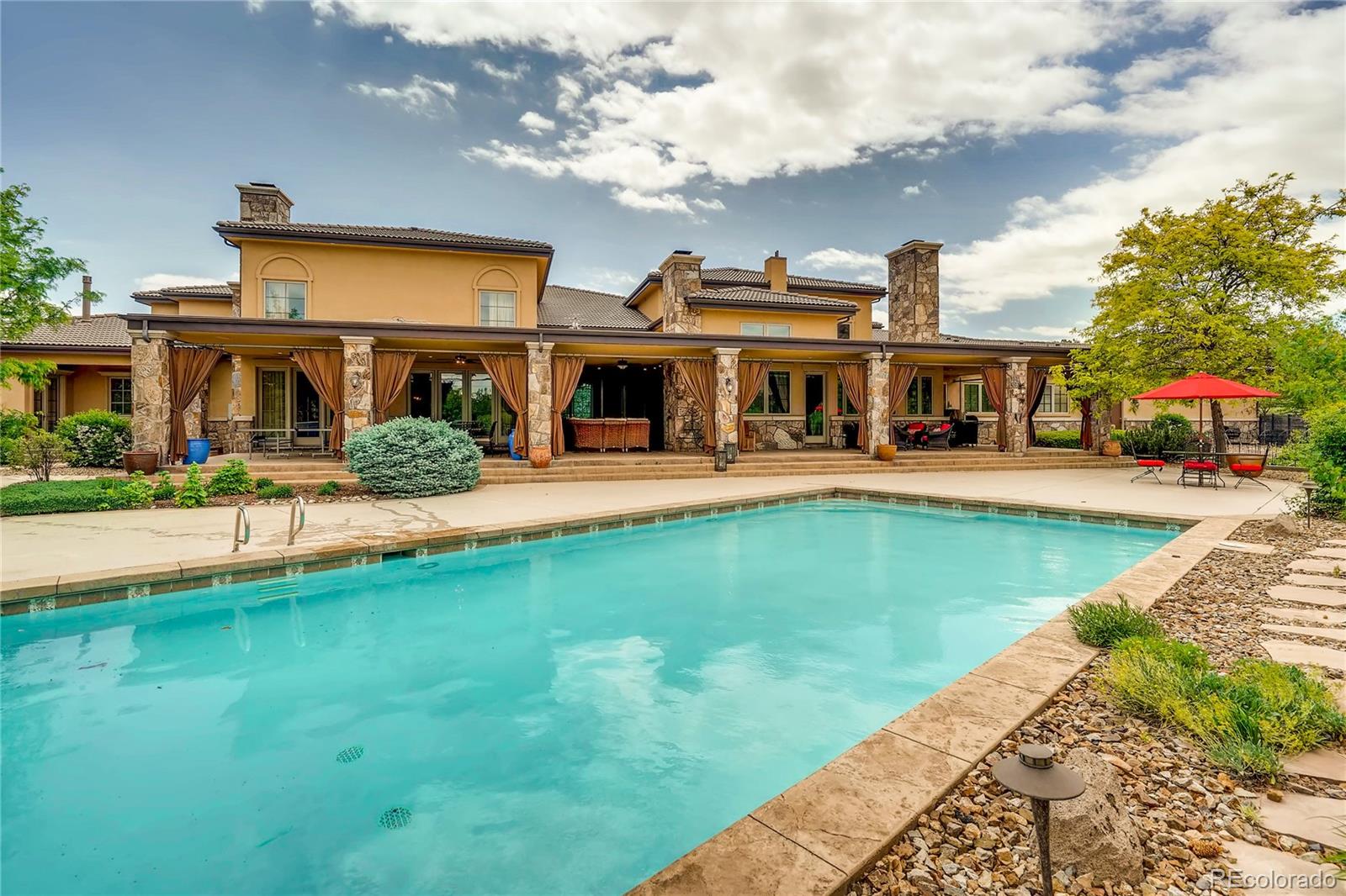 7390 Sagebrush Drive Parker, CO 80138 - Photo 37 of 40 a view of an house with swimming pool and chairs