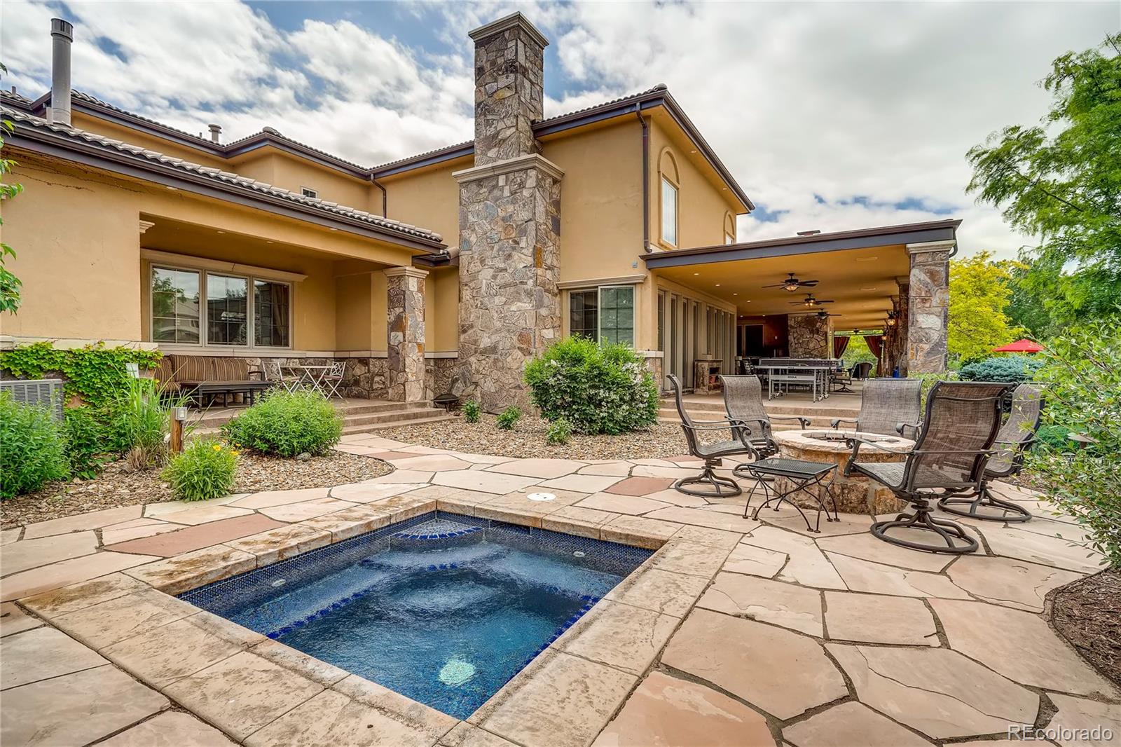7390 Sagebrush Drive Parker, CO 80138 - Photo 39 of 40 a view of a patio with table and chairs potted plants and a large tree