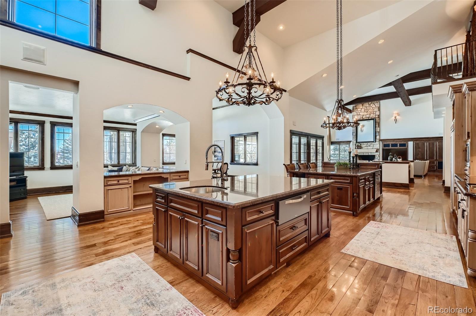 7390 Sagebrush Drive Parker, CO 80138 - Photo 8 of 40 a kitchen with stainless steel appliances granite countertop a stove and a refrigerator
