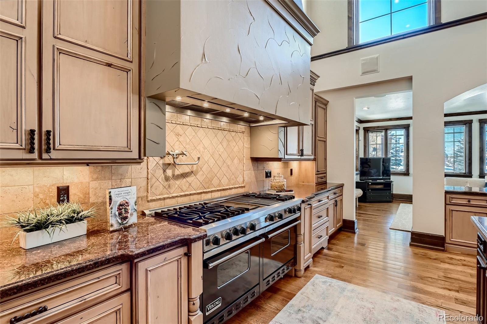 7390 Sagebrush Drive Parker, CO 80138 - Photo 9 of 40 a kitchen with stainless steel appliances granite countertop a sink stove and cabinets