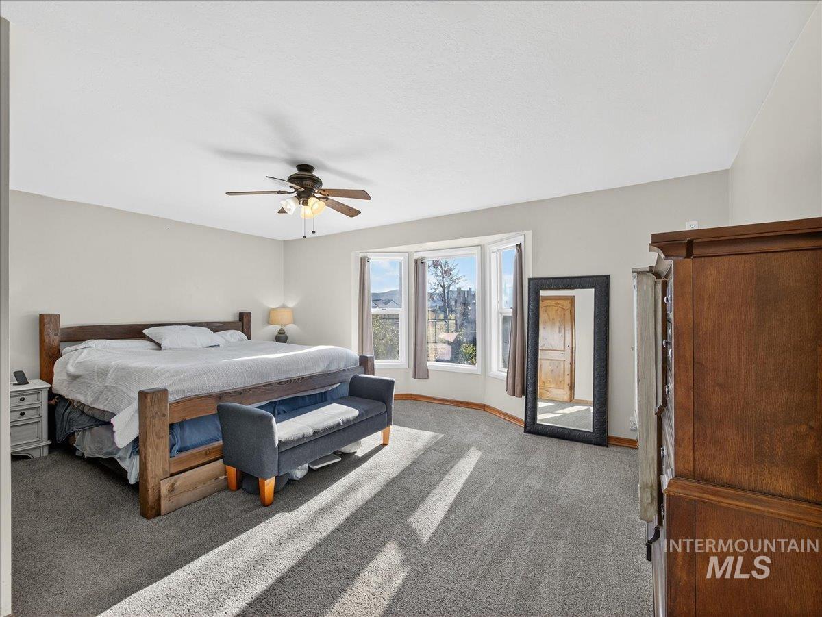 2588 West Sales Yard Road Emmett, ID 83617 - Photo 23 of 49 Bedroom with carpet and a ceiling fan