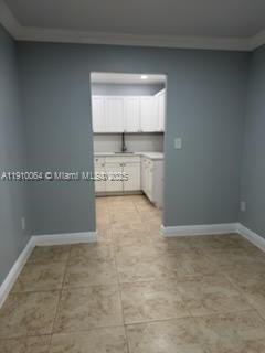 1805 West 56th Street, Unit 412 Hialeah, FL 33012 - Photo 4 of 18 a view of a refrigerator in kitchen and an empty room