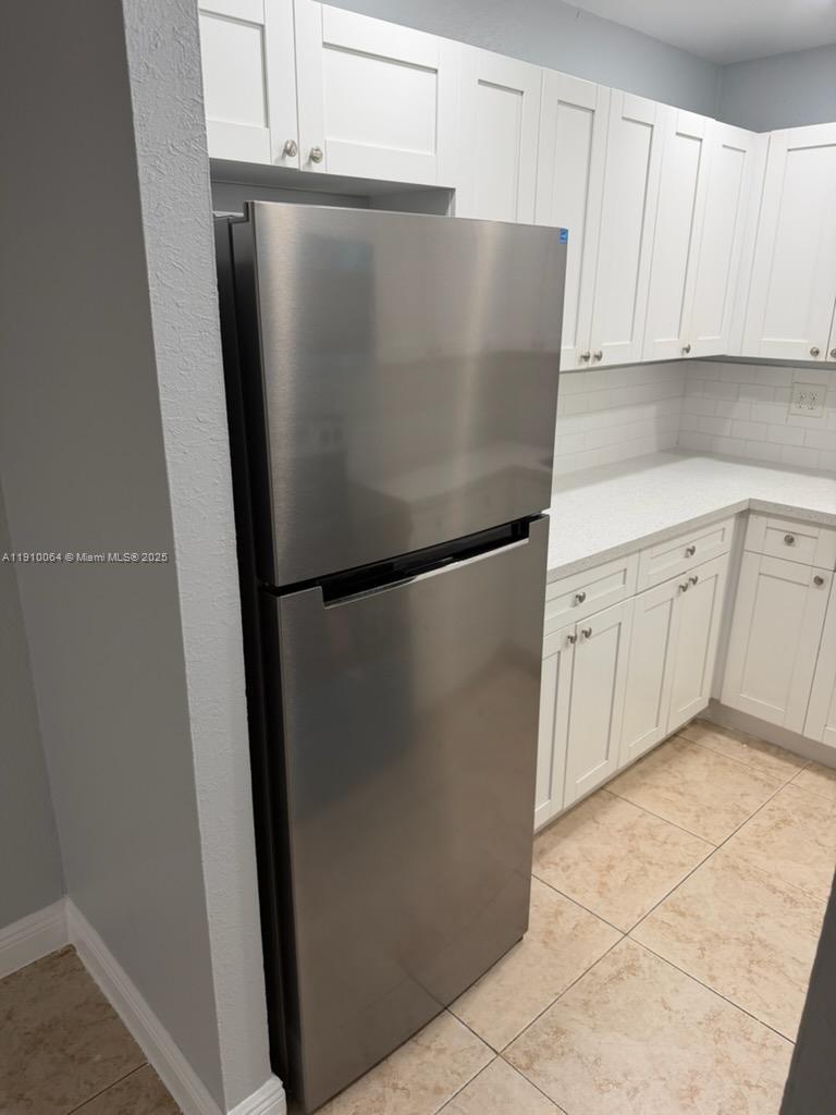 1805 West 56th Street, Unit 412 Hialeah, FL 33012 - Photo 5 of 18 a view of cabinets and refrigerator