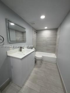 1805 West 56th Street, Unit 412 Hialeah, FL 33012 - Photo 9 of 18 a bathroom with a bathtub sink mirror and toilet