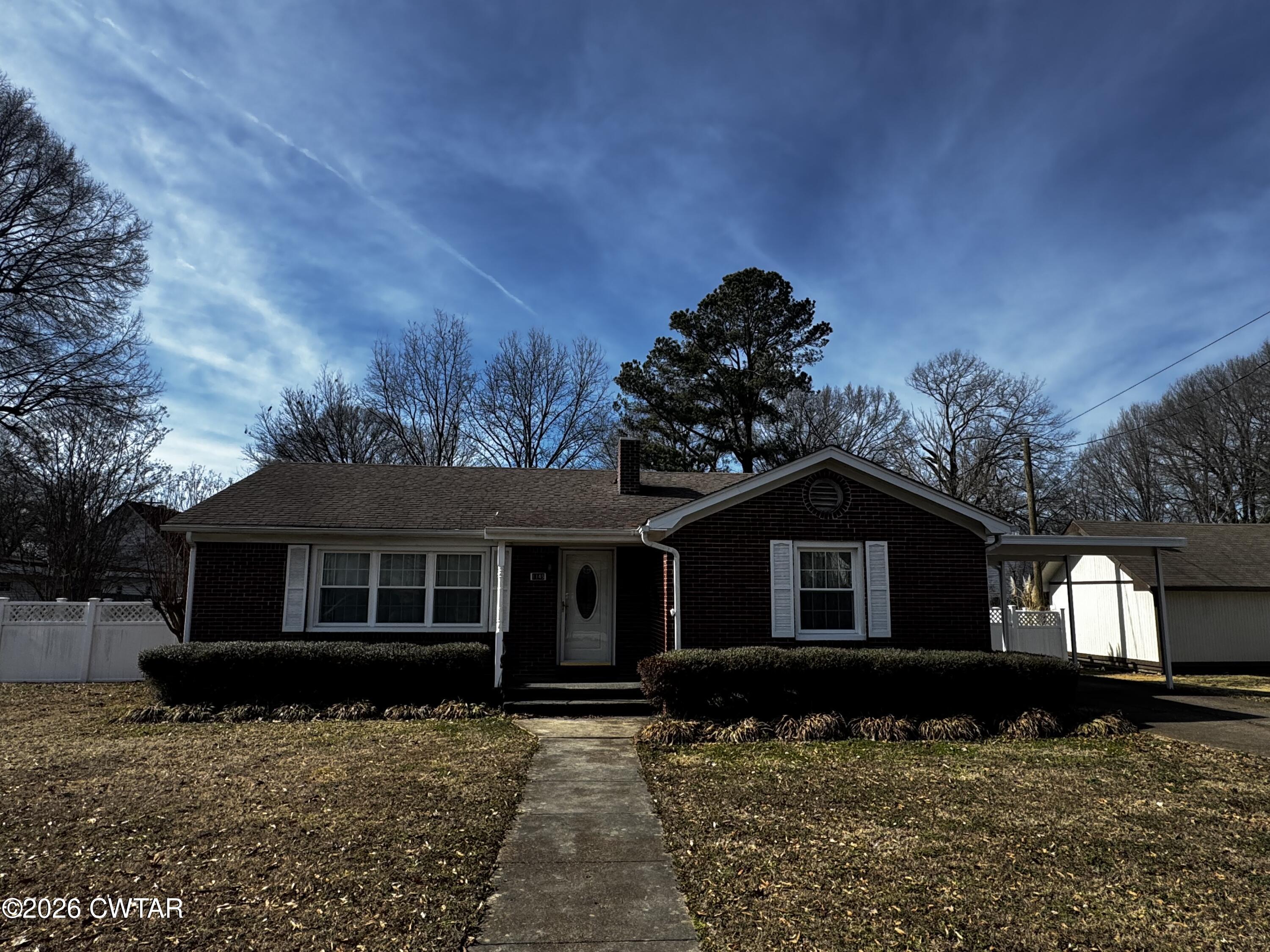 1149 Broad Street Milan, TN 38358 - Photo 1 of 19 a front view of a house with a yard