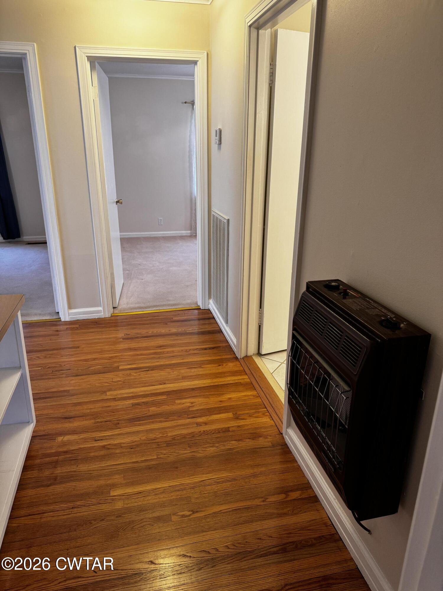 1149 Broad Street Milan, TN 38358 - Photo 13 of 19 a view of a hallway with wooden floor and staircase