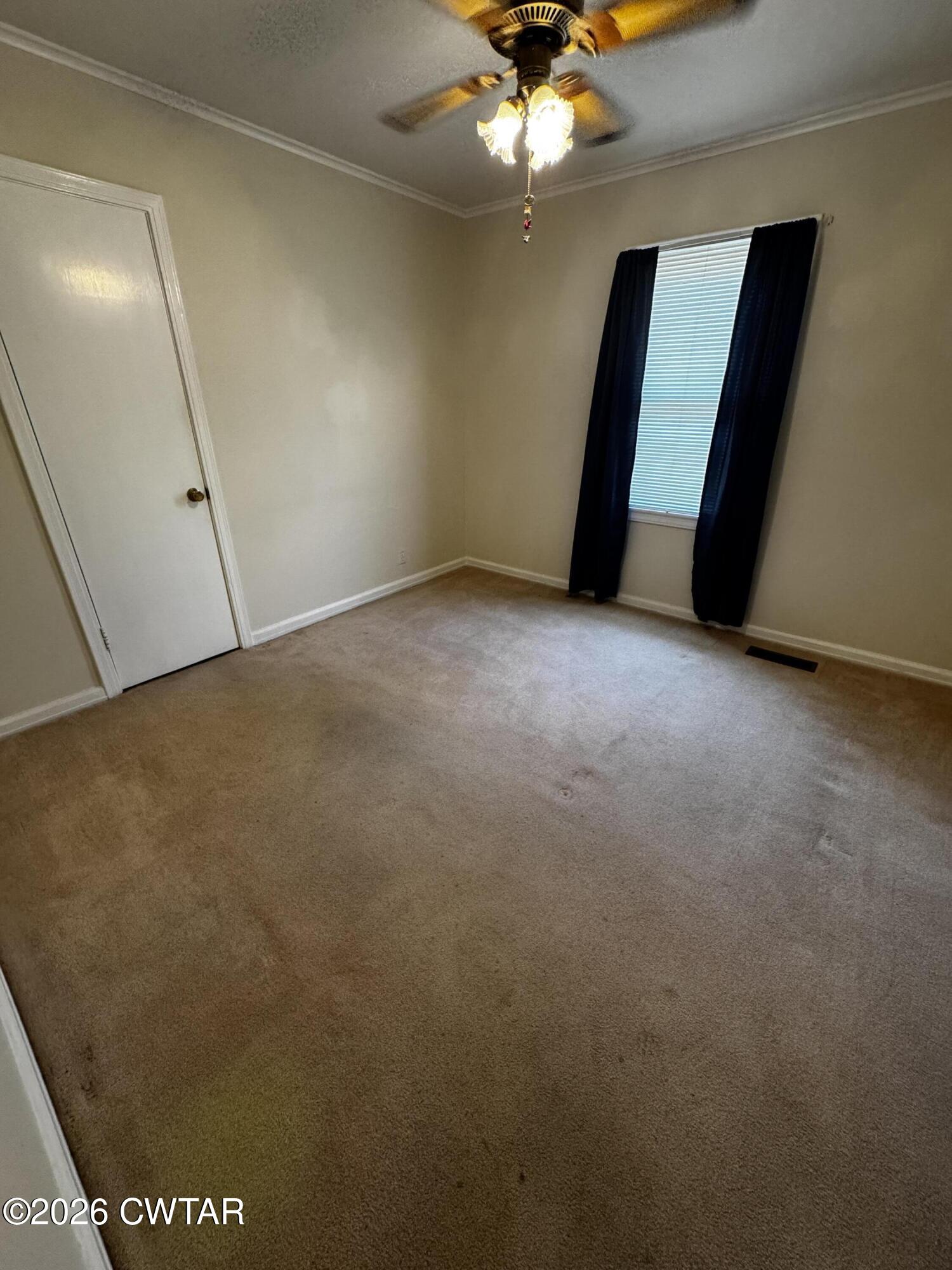 1149 Broad Street Milan, TN 38358 - Photo 15 of 19 wooden floor in an empty room with a window