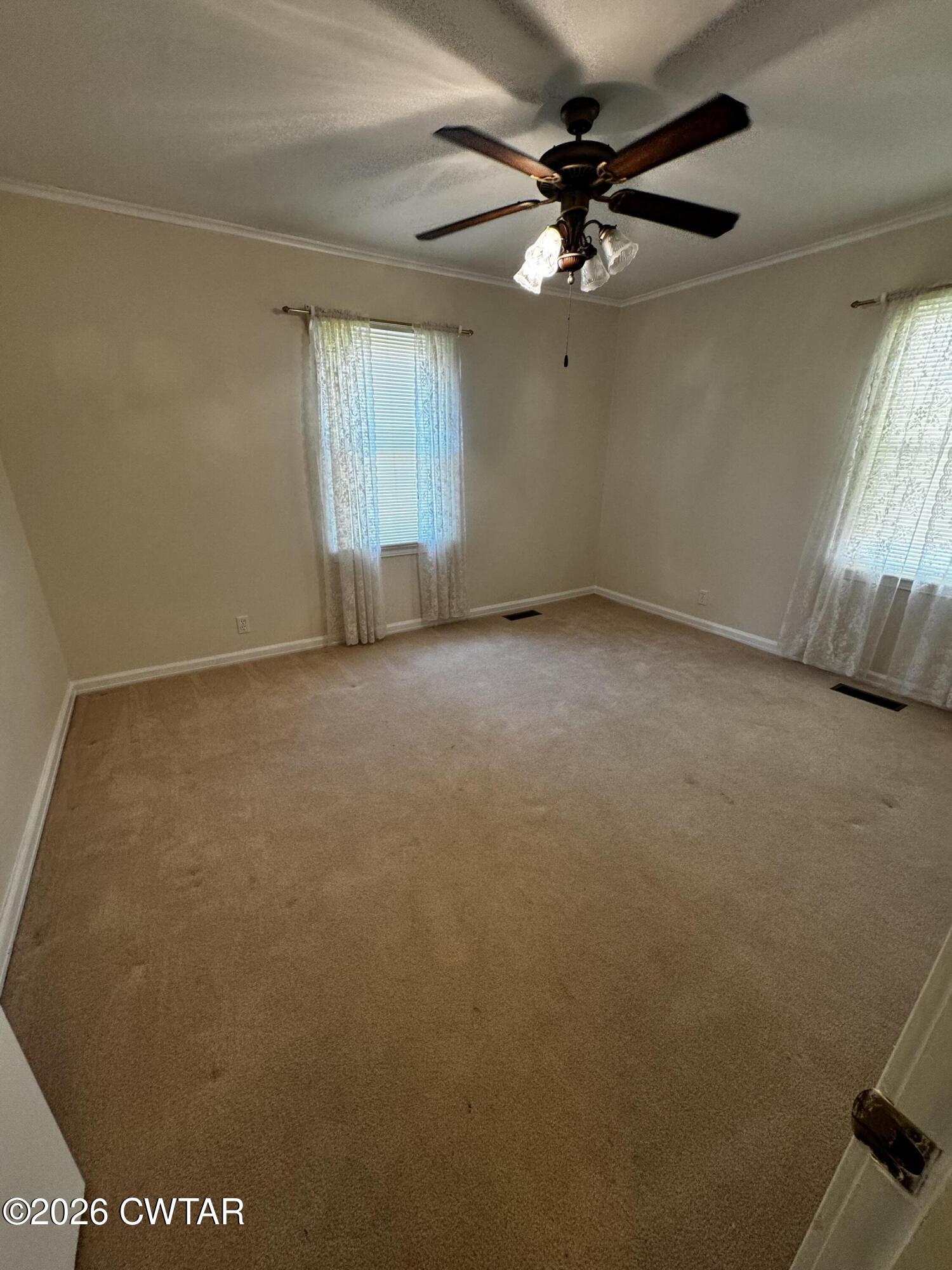 1149 Broad Street Milan, TN 38358 - Photo 18 of 19 an empty room with a window and a fan