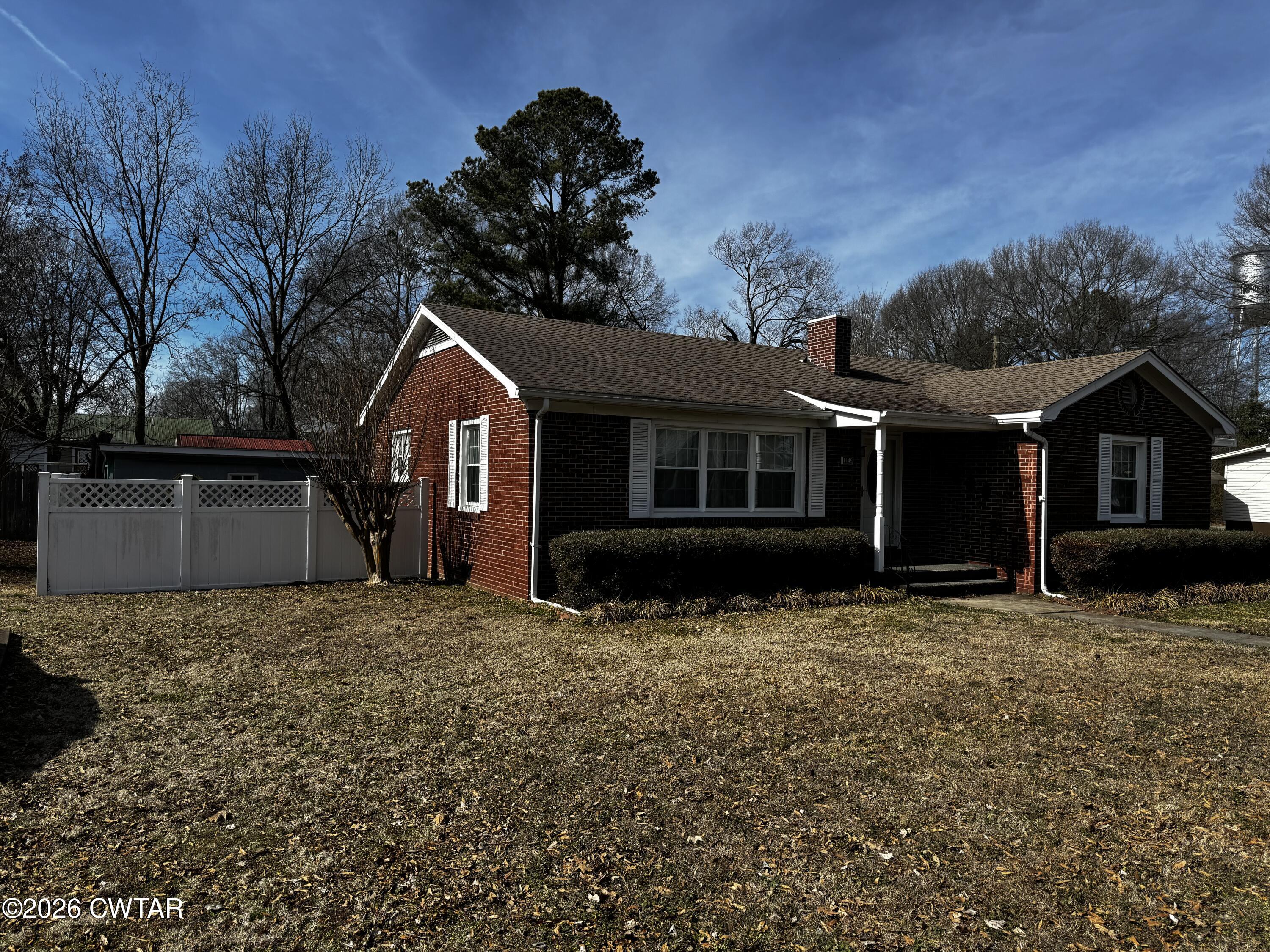 1149 Broad Street Milan, TN 38358 - Photo 2 of 19 a front view of a house with a yard