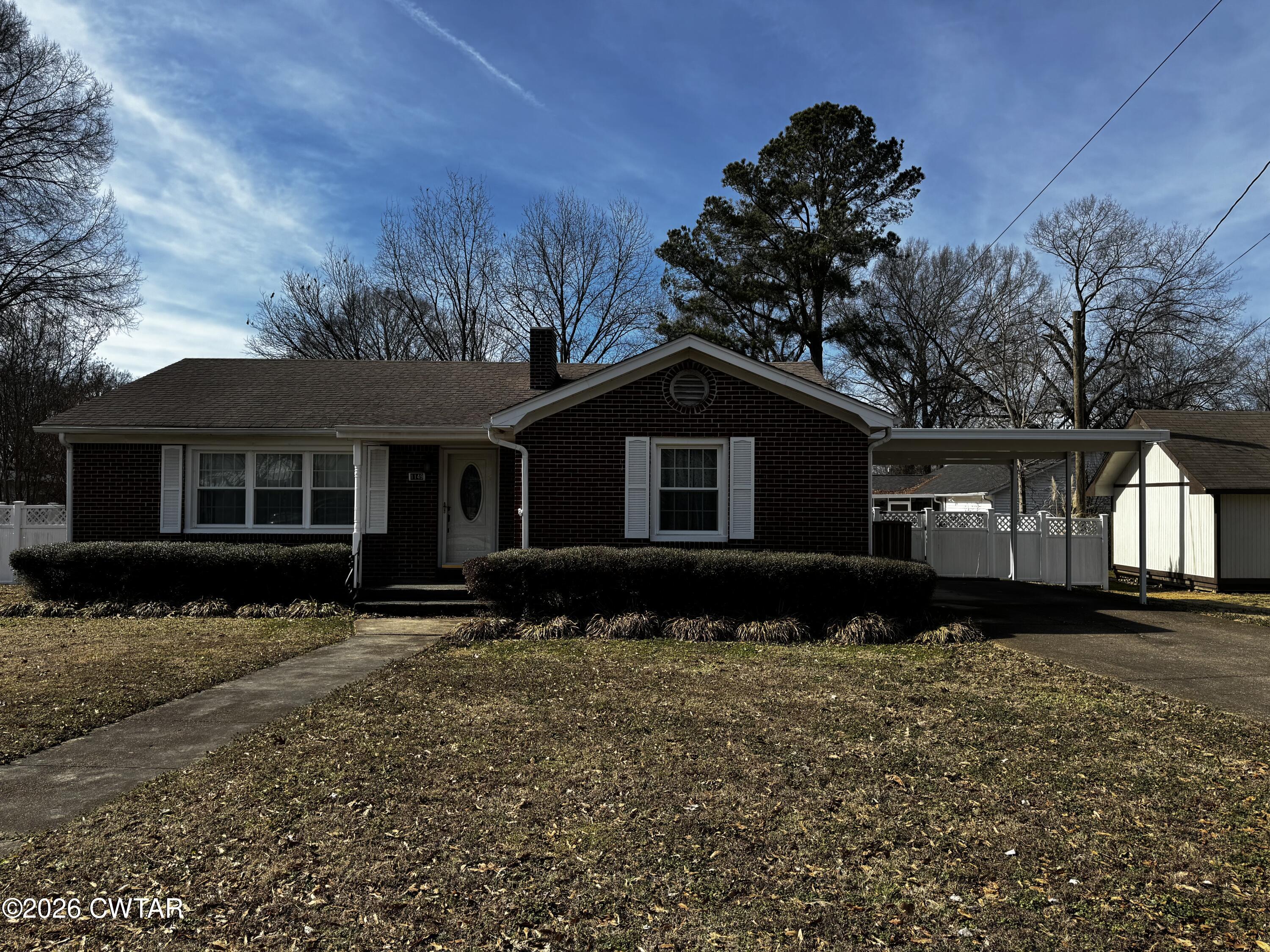 1149 Broad Street Milan, TN 38358 - Photo 4 of 19 a front view of a house with a yard