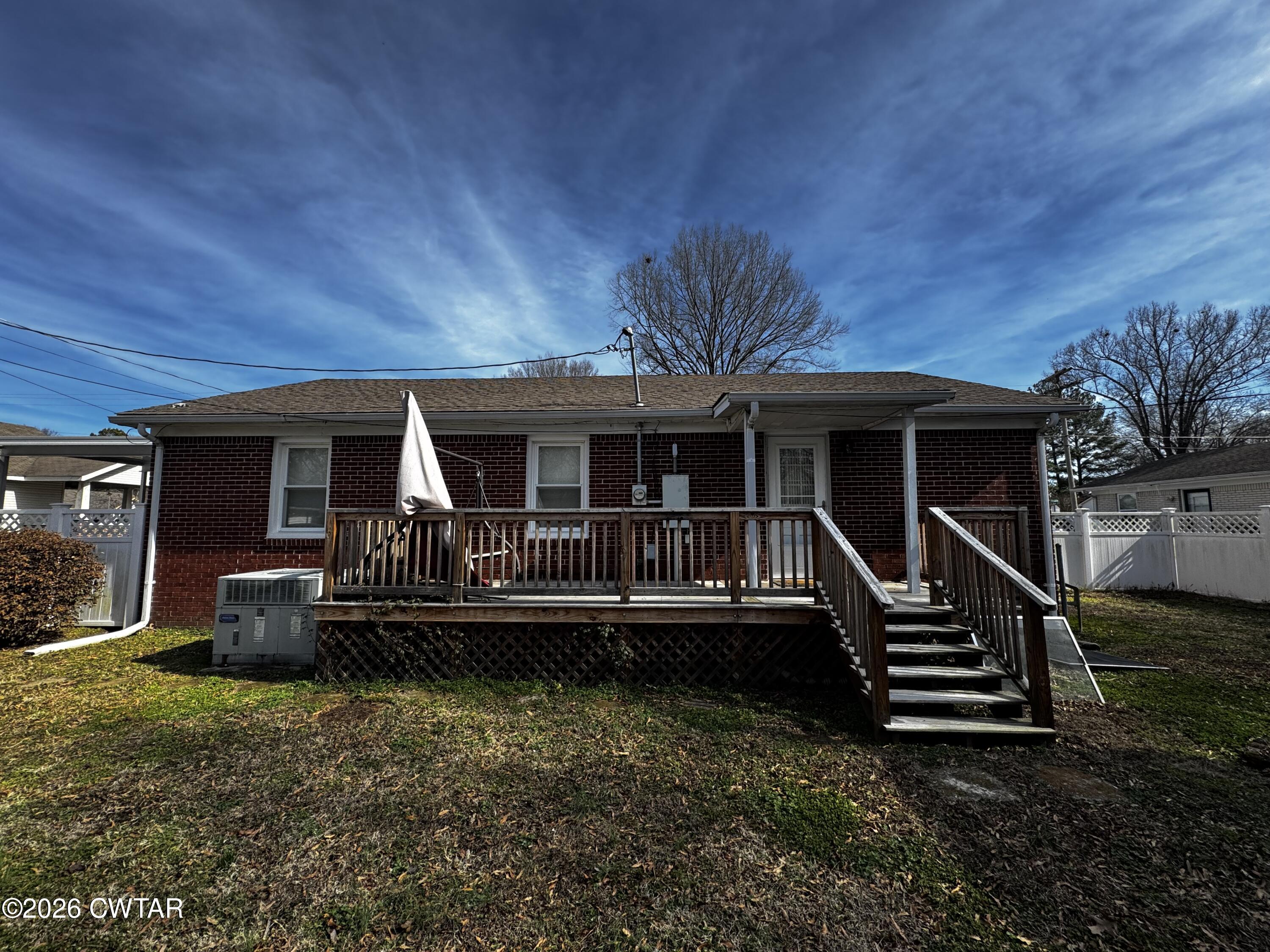 1149 Broad Street Milan, TN 38358 - Photo 5 of 19 a front view of a house with a yard