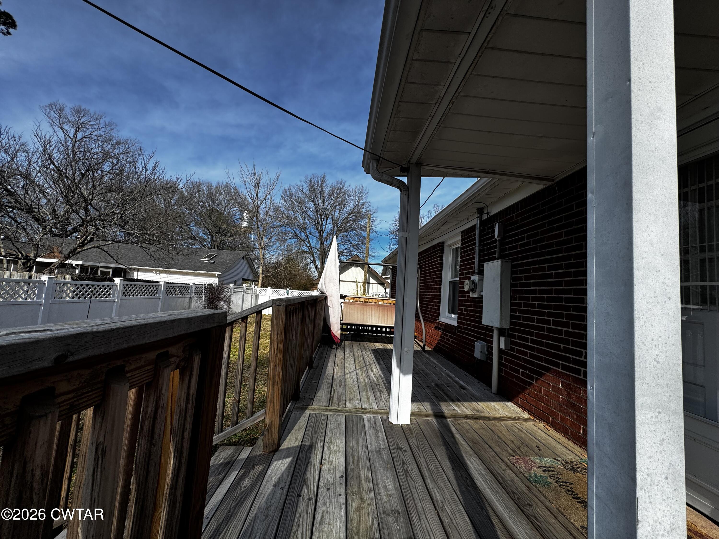 1149 Broad Street Milan, TN 38358 - Photo 6 of 19 a view of a balcony with furniture and wooden floor