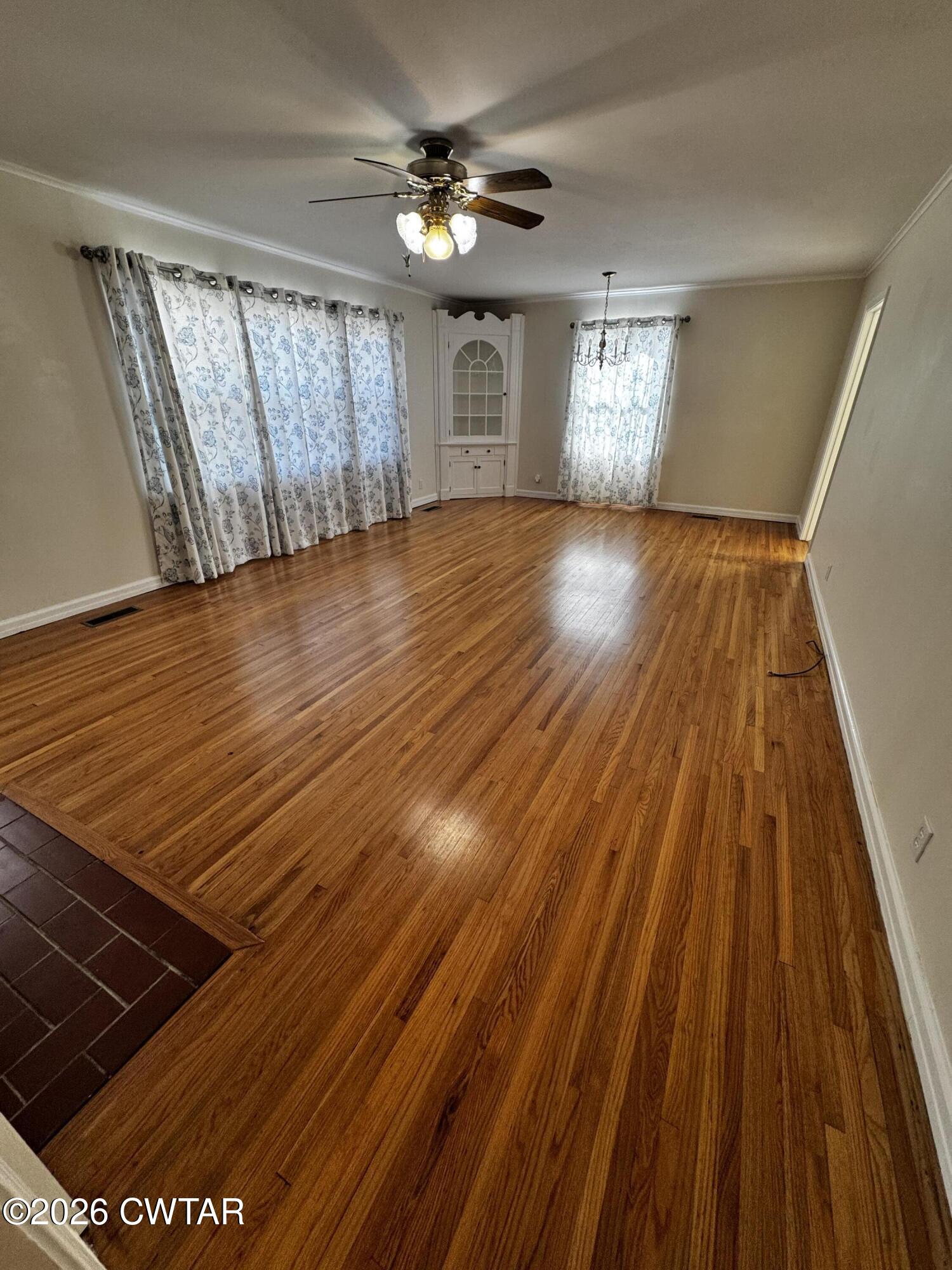1149 Broad Street Milan, TN 38358 - Photo 7 of 19 a view of an empty room with wooden floor and a window