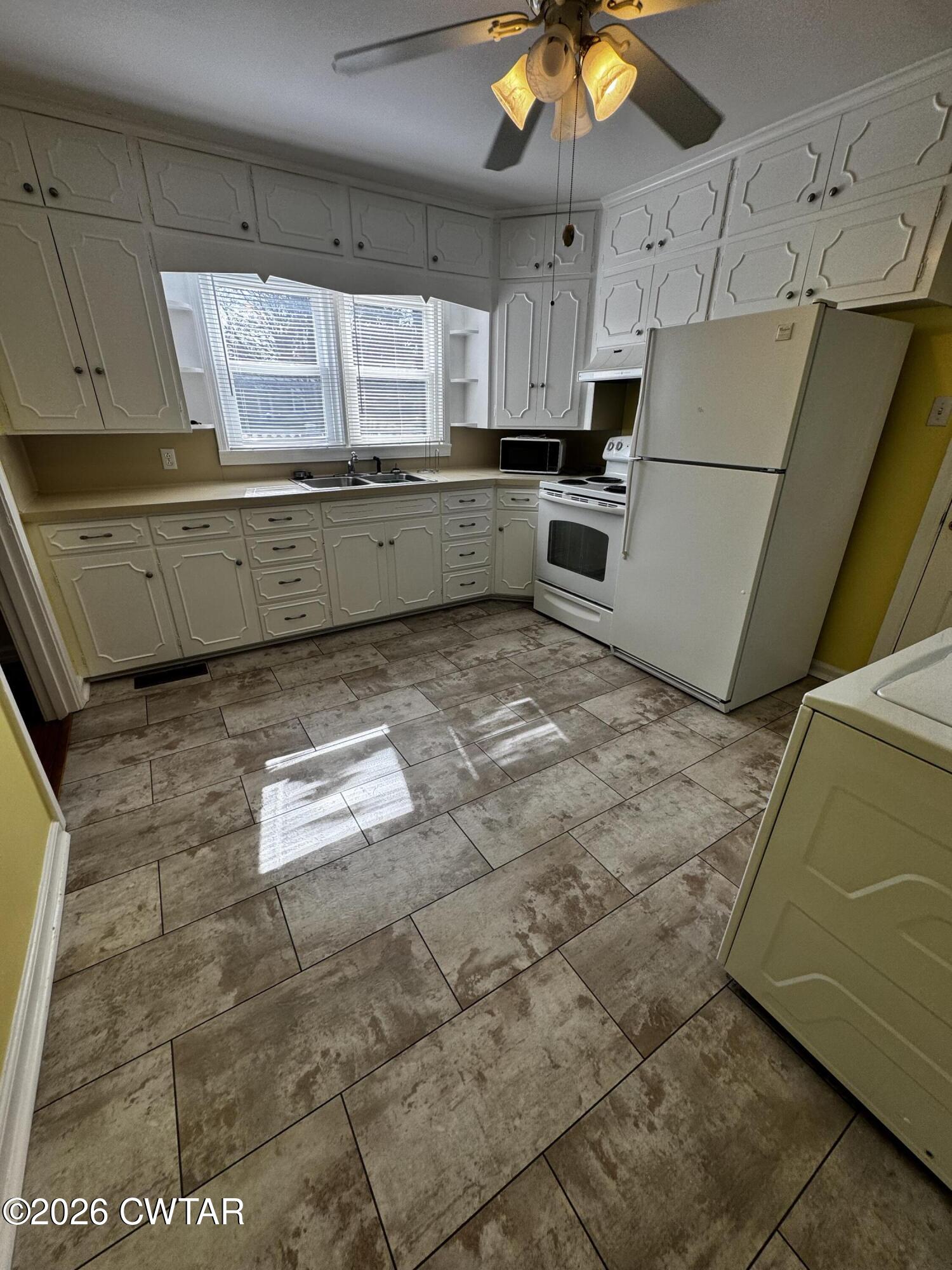 1149 Broad Street Milan, TN 38358 - Photo 9 of 19 a kitchen with a cabinets and window