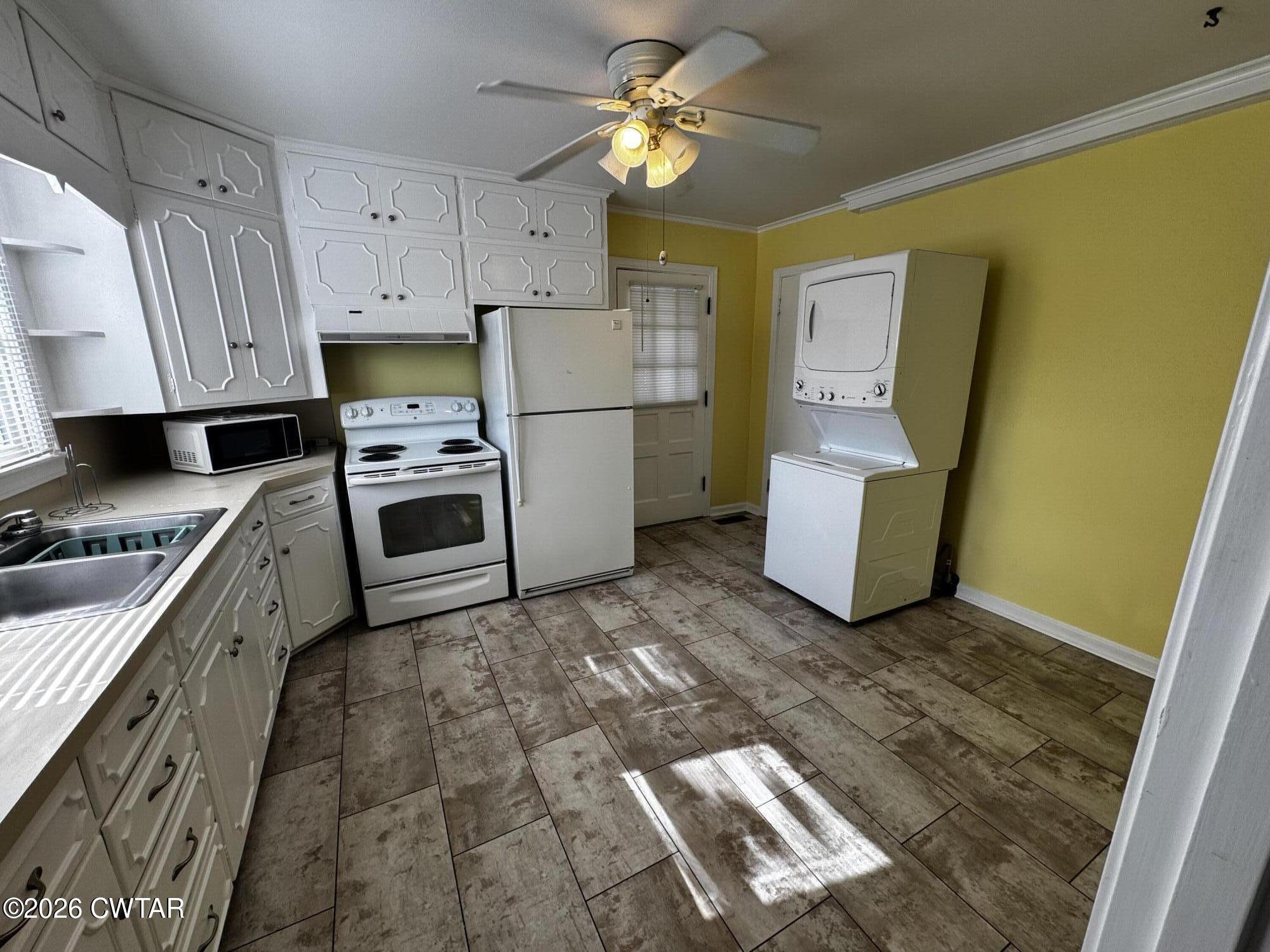 1149 Broad Street Milan, TN 38358 - Photo 10 of 19 a kitchen with a stove a refrigerator and a sink