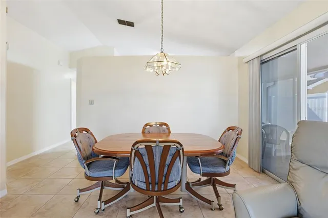a view of a dining room with furniture and chandelier