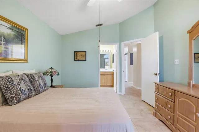 a bedroom with a large bed and a dresser