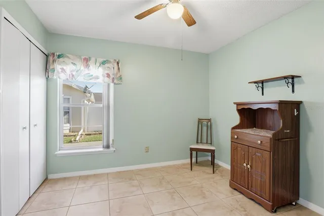 a view of kitchen with furniture and electronic appliances