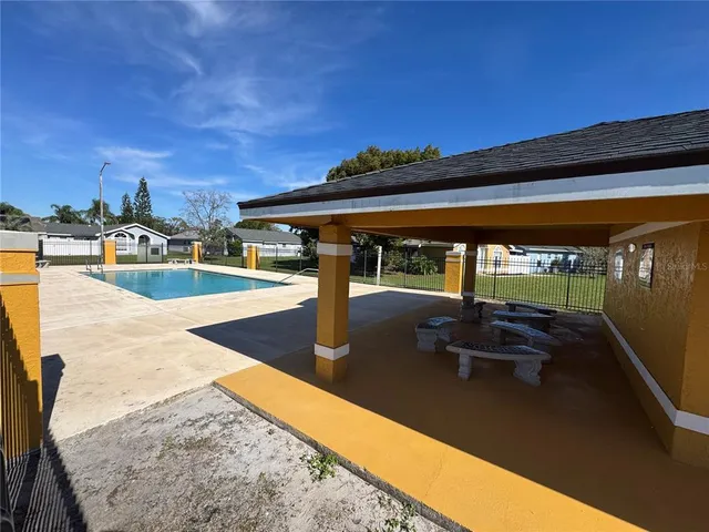 a view of a swimming pool with a lawn chairs