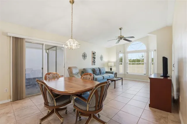 a dining room with furniture a chandelier and window