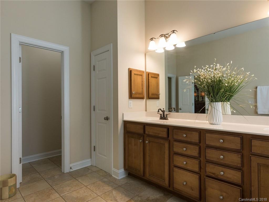 3325 Richard's Crossing Fort Mill, SC 29708 - Photo 23 of 36 a spacious bathroom with a granite countertop sink a large mirror and a shower