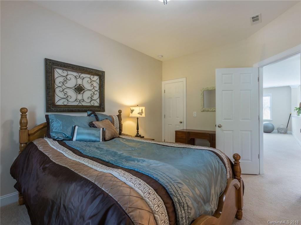 3325 Richard's Crossing Fort Mill, SC 29708 - Photo 28 of 36 a bedroom with a bed and a chandelier