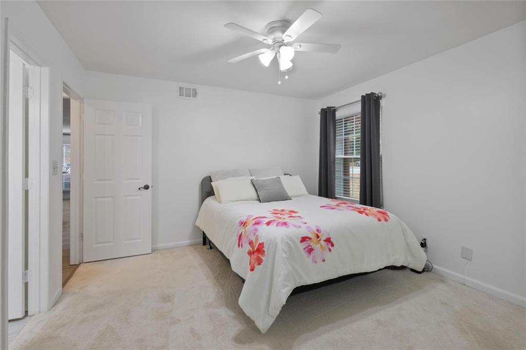 102 Hawkstone Way Alpharetta, GA 30022 - Photo 11 of 22 a bedroom with a bed and a chandelier