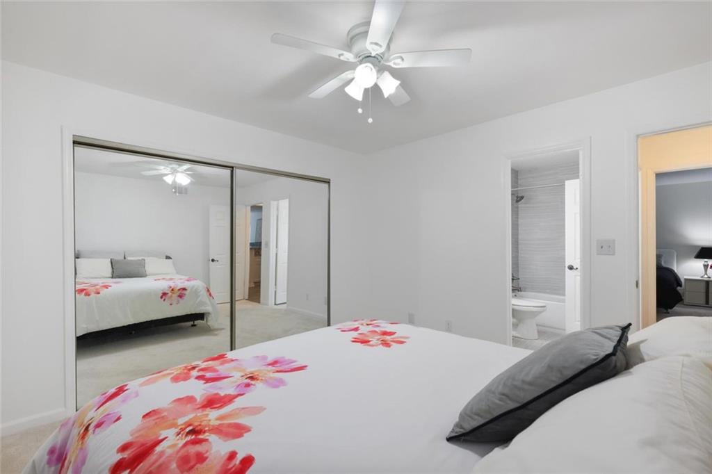 102 Hawkstone Way Alpharetta, GA 30022 - Photo 12 of 22 a bedroom with a bed and a chandelier