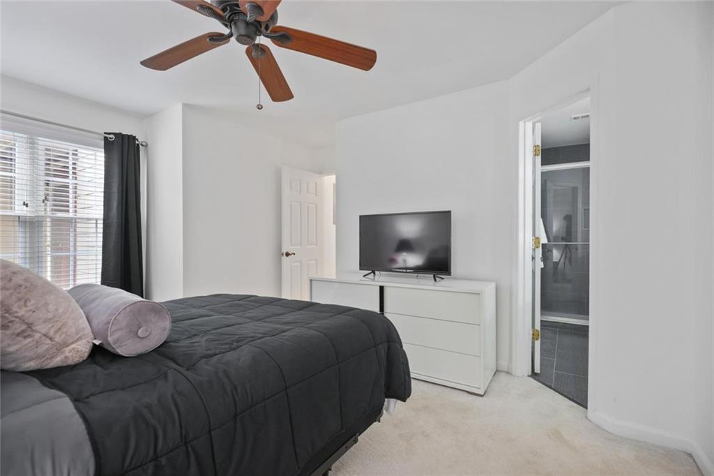 102 Hawkstone Way Alpharetta, GA 30022 - Photo 15 of 22 a bedroom with a bed and a flat screen tv