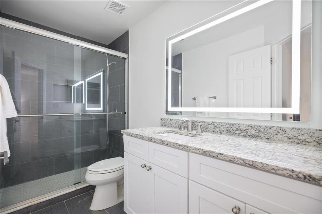 102 Hawkstone Way Alpharetta, GA 30022 - Photo 17 of 22 a bathroom with a granite countertop sink toilet and shower