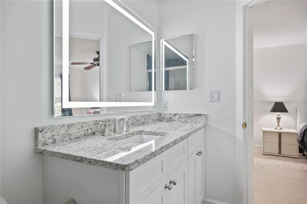102 Hawkstone Way Alpharetta, GA 30022 - Photo 19 of 22 a bathroom with a granite countertop sink and a mirror