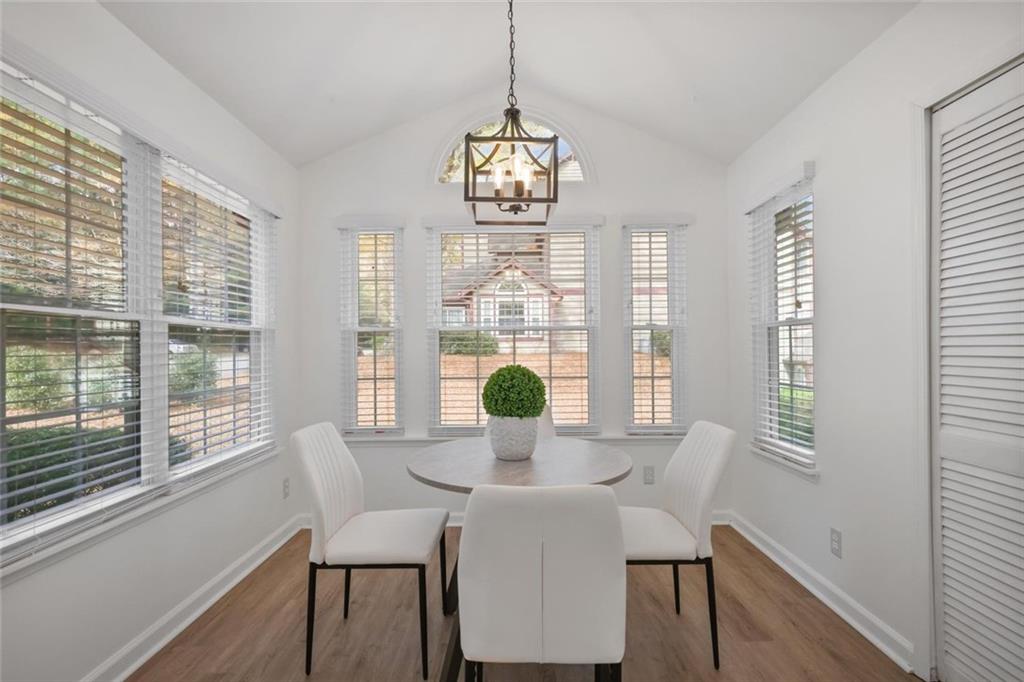 102 Hawkstone Way Alpharetta, GA 30022 - Photo 2 of 22 a view of a dining room with furniture wooden floor and chandelier