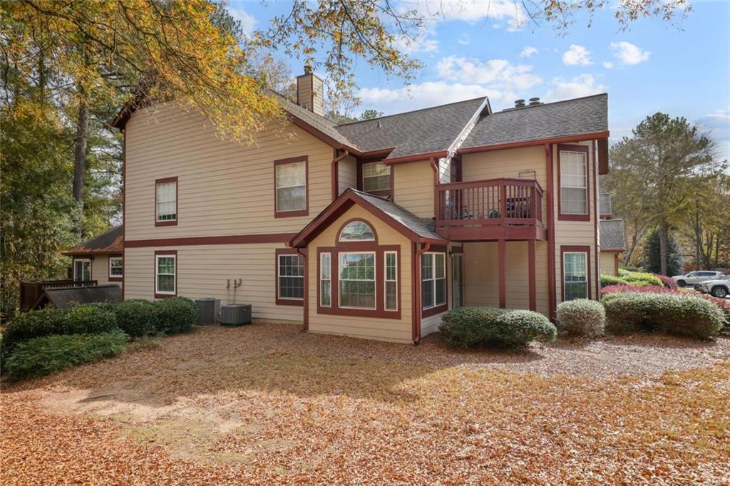 102 Hawkstone Way Alpharetta, GA 30022 - Photo 21 of 22 a front view of a house with a garden and plants