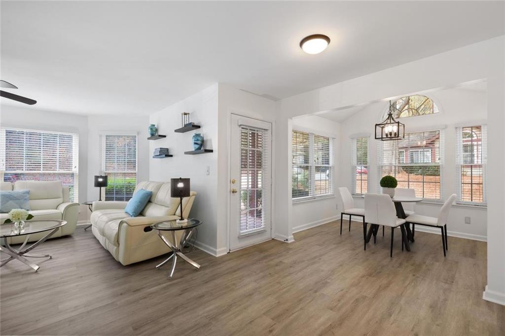 102 Hawkstone Way Alpharetta, GA 30022 - Photo 5 of 22 a living room with furniture a table and wooden floor
