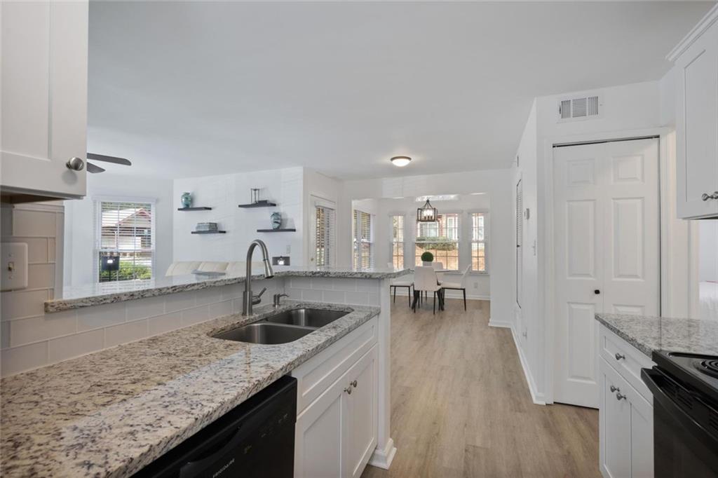 102 Hawkstone Way Alpharetta, GA 30022 - Photo 8 of 22 a kitchen with granite countertop a sink a stove and cabinets