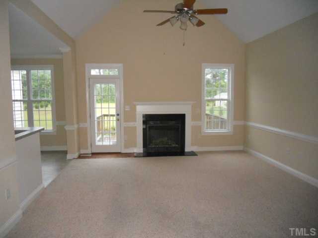 5939 Sandford Road Wilson, NC 27896 - Photo 3 of 10 an empty room with windows and fireplace