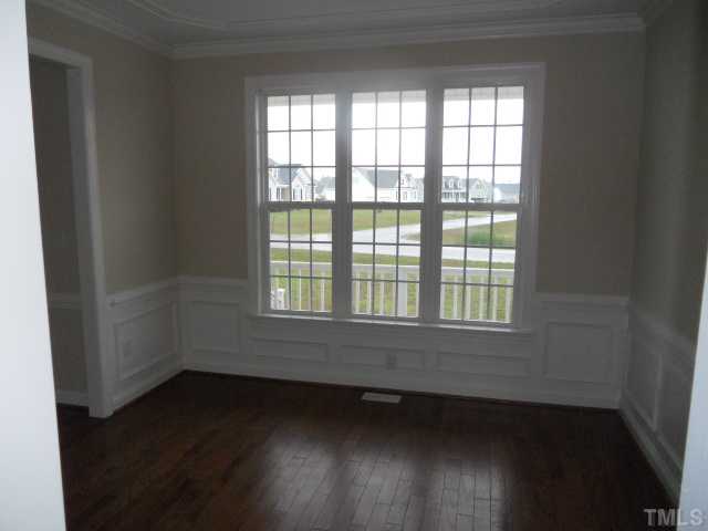 5939 Sandford Road Wilson, NC 27896 - Photo 5 of 10 an empty room with wooden floor and windows