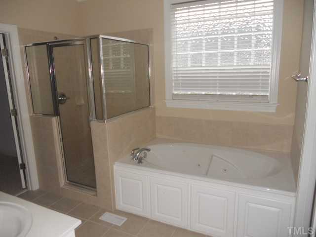 5939 Sandford Road Wilson, NC 27896 - Photo 7 of 10 a bathroom with a bathtub and a shower